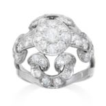 A DIAMOND DRESS RING in platinum or white gold, bombe form with openwork scroll design, jewelled