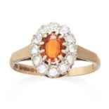 A CITRINE AND DIAMOND CLUSTER RING in 9ct yellow gold, set with an oval cut citrine in a cluster