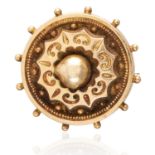 A GOLD MOURNING BROOCH in yellow gold, in circular engraved form, with hair-work locket back,