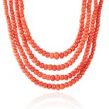 AN ANTIQUE CORAL BEAD NECKLACE in high carat yellow gold, the four rows of graduated, polished beads