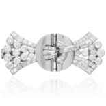 AN ART DECO DIAMOND CLIP BROOCH in platinum or white gold, in circle and bow motif, jewelled with