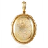 AN ANTIQUE GOLD LOCKET in high carat yellow gold, with engraved front and six glass picture lockets,