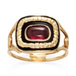 AN ANTIQUE GEORGIAN GARNET AND ENAMEL MOURNING RING in high carat yellow gold, the cabochon garnet