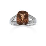 A SMOKEY QUARTZ AND DIAMOND DRESS RING in 9ct white gold, set with a central faceted smokey quartz,