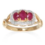 A RUBY AND DIAMOND DRESS RING in 9ct yellow gold, set with three round cut rubies in a border of