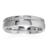 A DIAMOND RING in platinum, set with a row of round cut diamonds, full British hallmarks, size M /