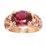 A GARNET AND DIAMOND RING, MAUBOUSSIN in 18ct rose gold, set with a central oval cut garnet with