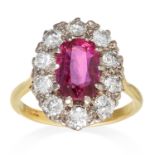 A 3.02 CARAT RUBY AND DIAMOND CLUSTER RING in 18ct yellow gold, designed as a 3.02 carat ruby set in