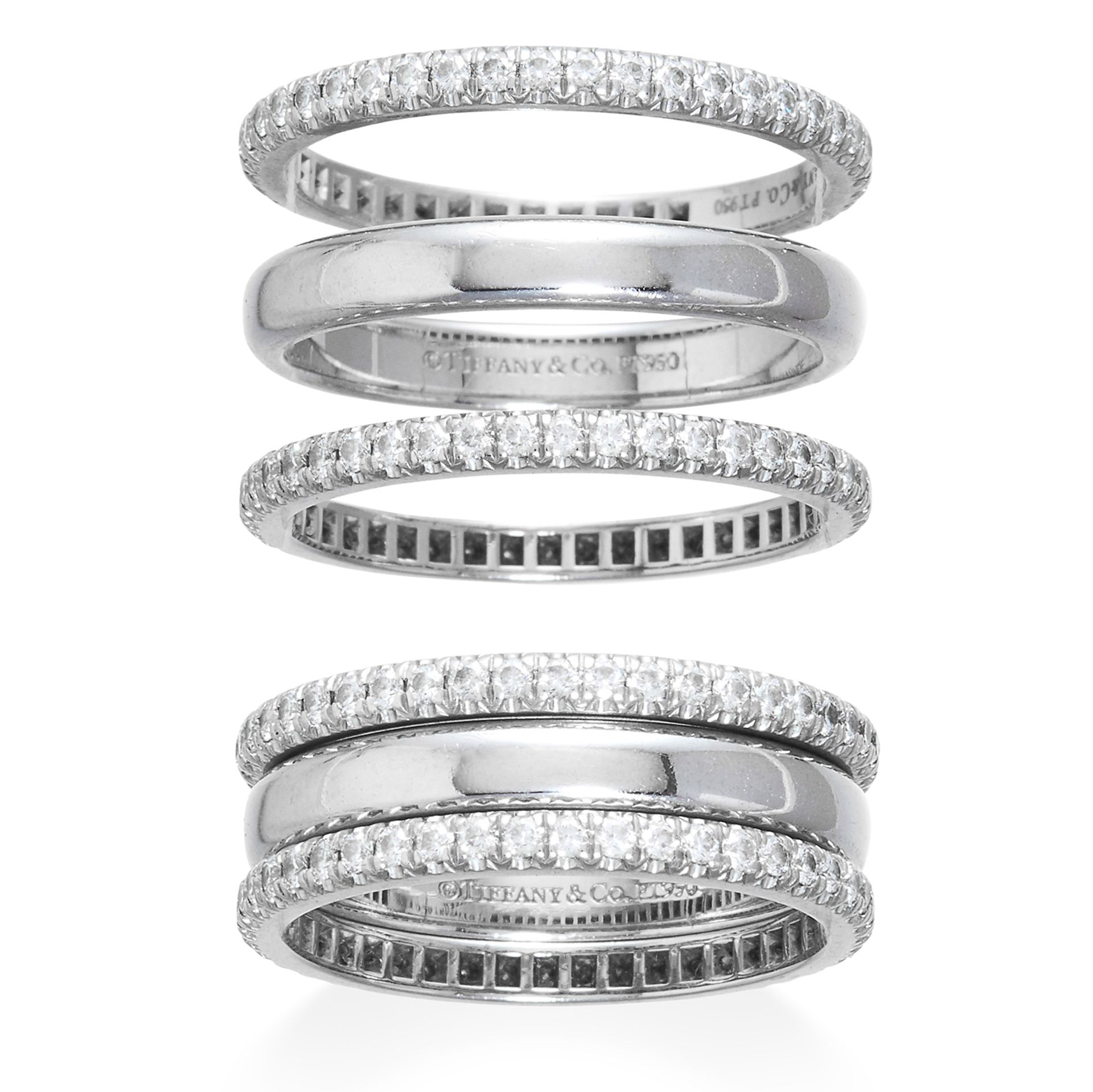 A TRIO OF DIAMOND ETERNITY RINGS, TIFFANY & CO in platinum, the central classic wedding band between