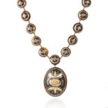 AN ANTIQUE TORTOISESHELL PIQUE NECKLACE, 19TH CENTURY the large oval pique decorated amulet