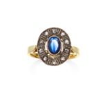 A SAPPHIRE AND DIAMOND RING in high carat yellow gold and silver, the oval cut sapphire of 0.80