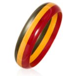 AN ART DECO BAKELITE BANGLE, EARLY 20TH CENTURY the bevelled circular design in red, yellow and