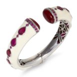 A RUBY AND ENAMEL BANGLE, MATTHEW CAMPBELL LAURENZA in silver, in cream enamel, designed with a snap