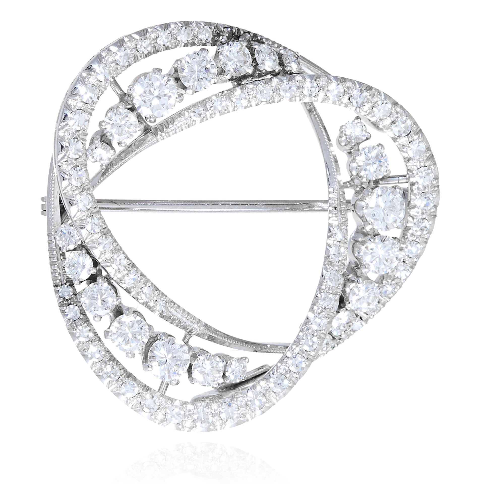 A DIAMOND BROOCH in white gold or platinum, in abstract circular form, jewelled with round cut