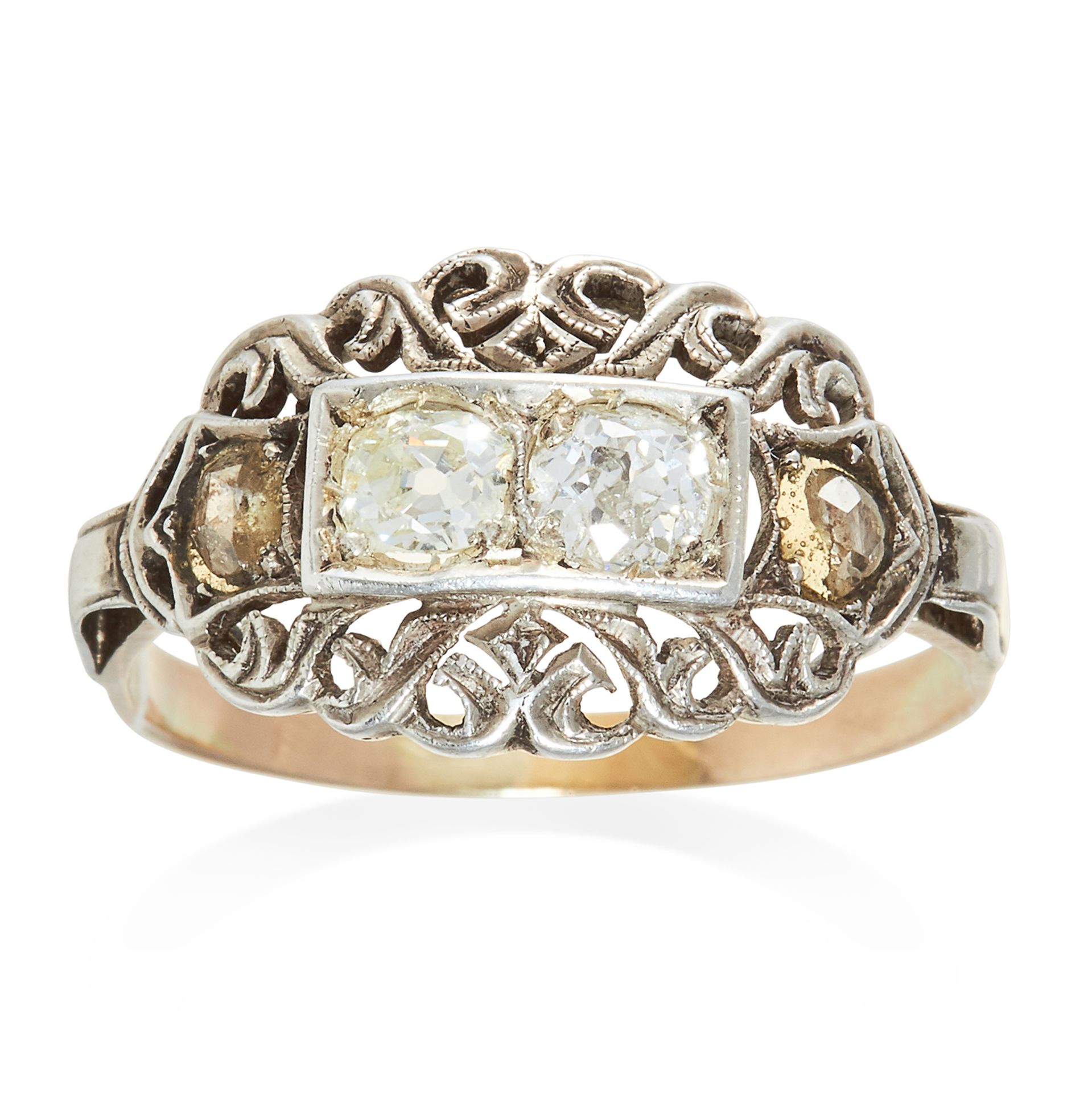 AN ANTIQUE DIAMOND RING in platinum or white gold, set with four diamonds among scrolling motifs,