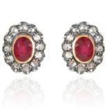 A PAIR OF RUBY AND DIAMOND CLUSTER EARRINGS in high carat yellow gold and silver, each set with a