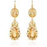 A PAIR OF ANTIQUE CITRINE EARRINGS in high carat yellow gold, each set with an oval cut citrine