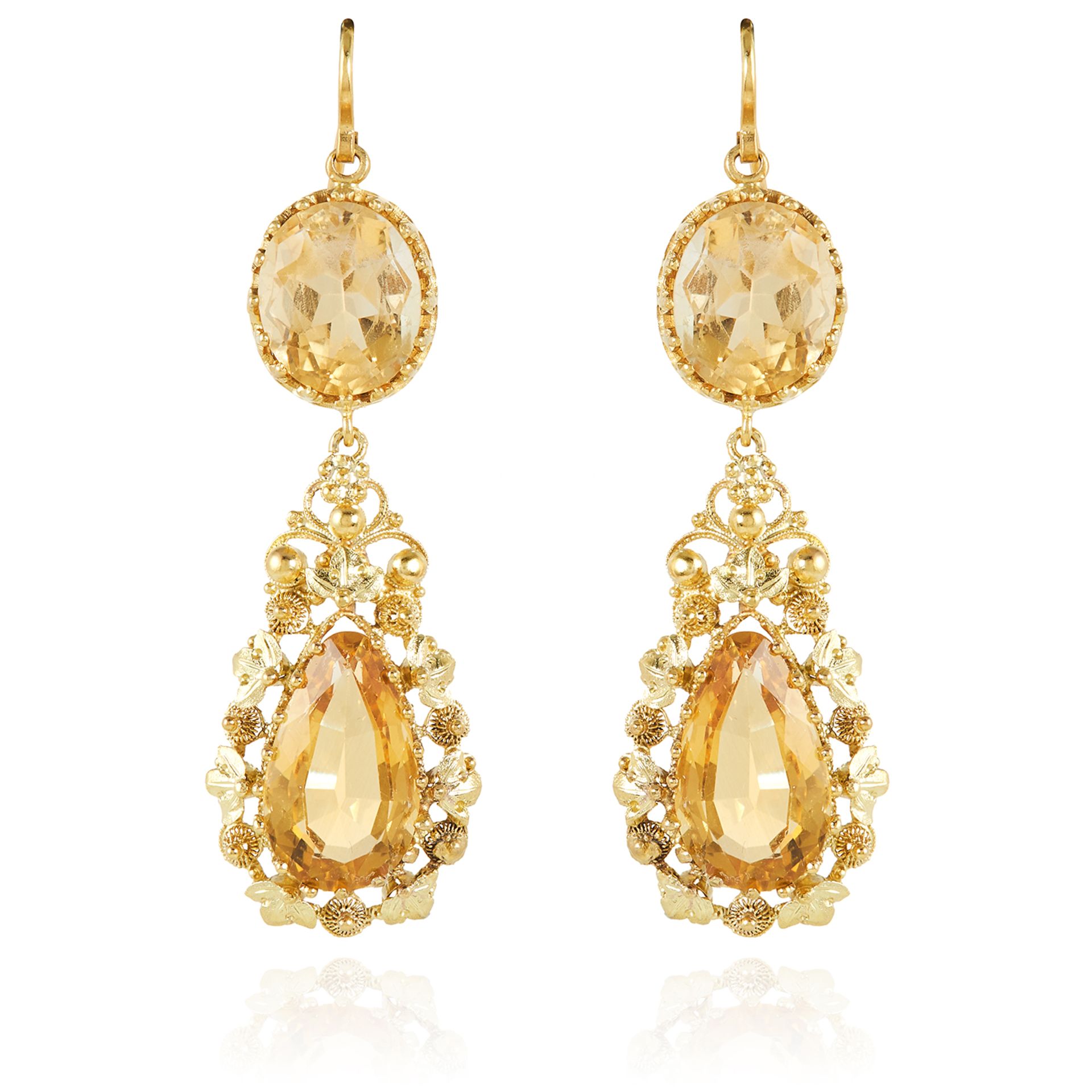A PAIR OF ANTIQUE CITRINE EARRINGS in high carat yellow gold, each set with an oval cut citrine