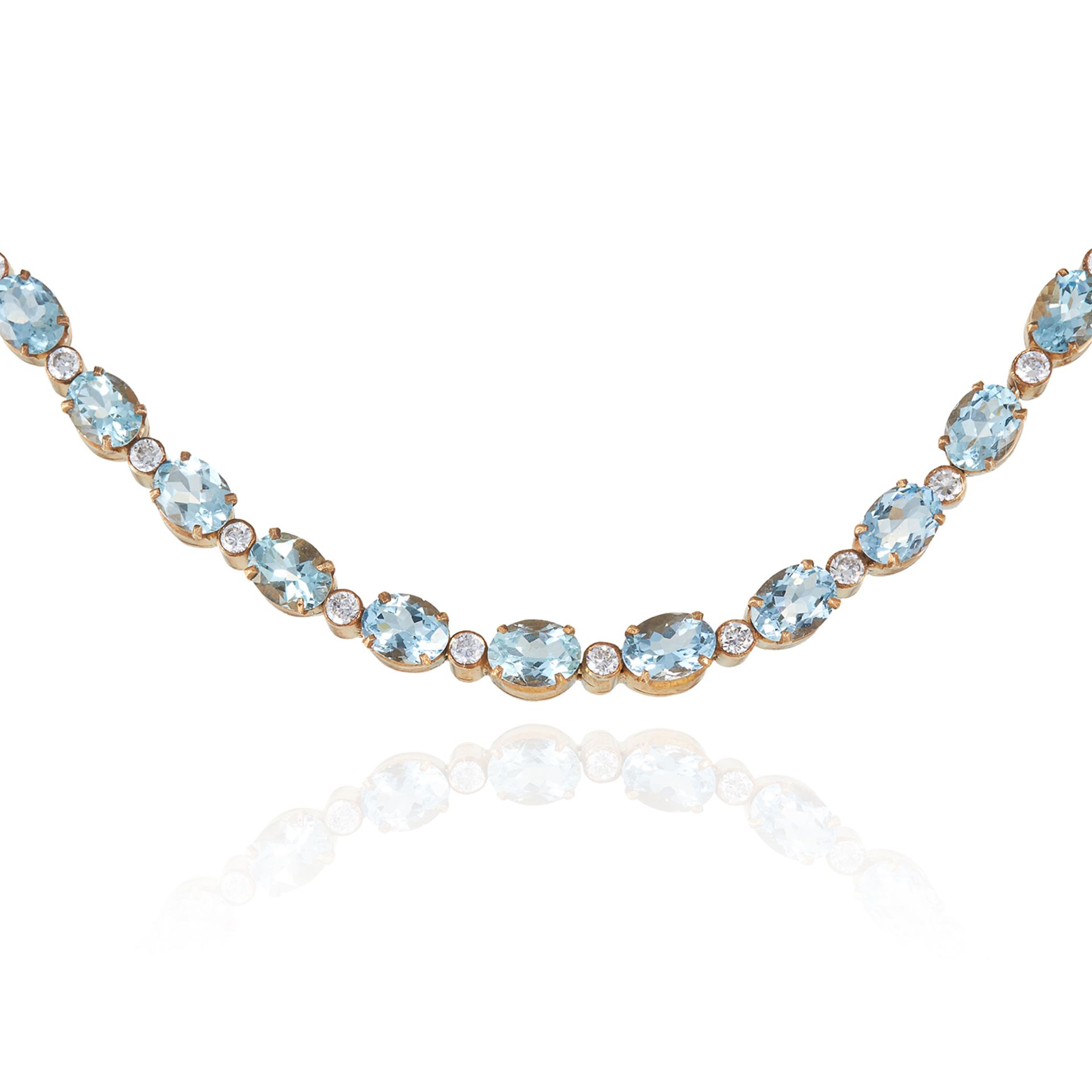 AN AQUAMARINE AND DIAMOND RIVIERA NECKLACE in yellow gold, set with oval cut aquamarines totalling