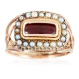 AN ANTIQUE GARNET AND SEED PEARL MOURNING RING, CIRCA 1830 in high carat yellow gold, set with an