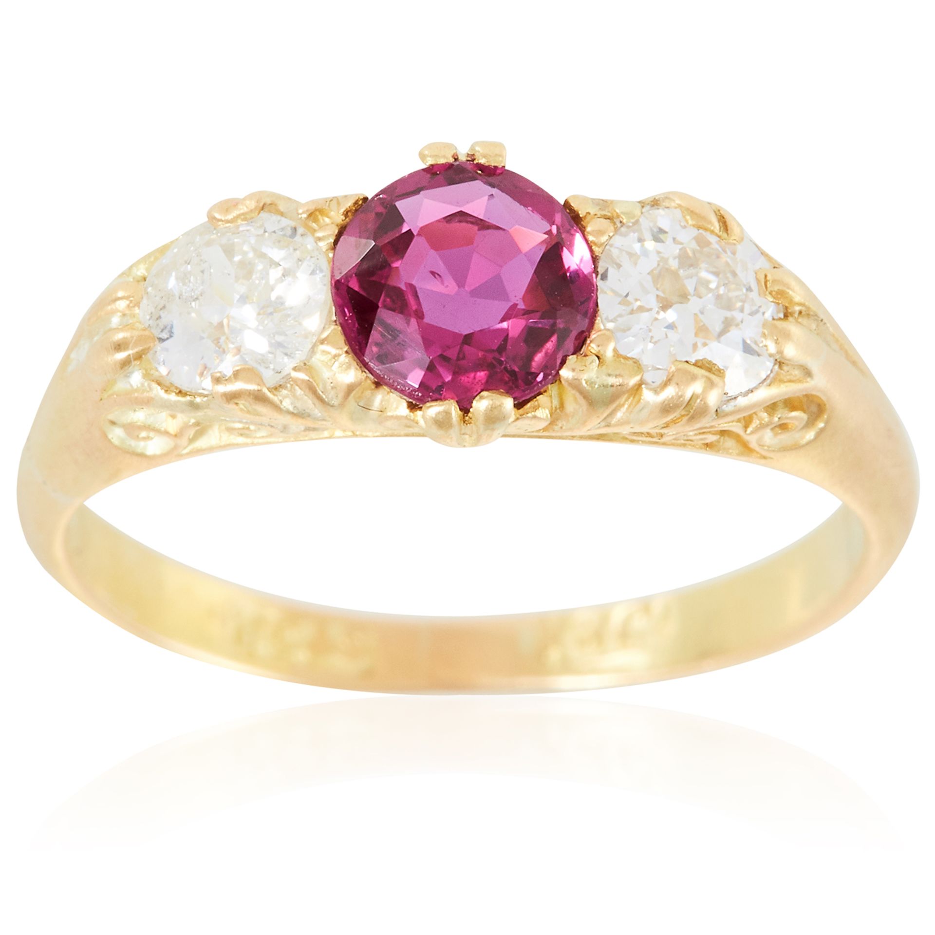 AN ANTIQUE RUBY AND DIAMOND THREE STONE RING in 18ct yellow gold, set with a round cut ruby of