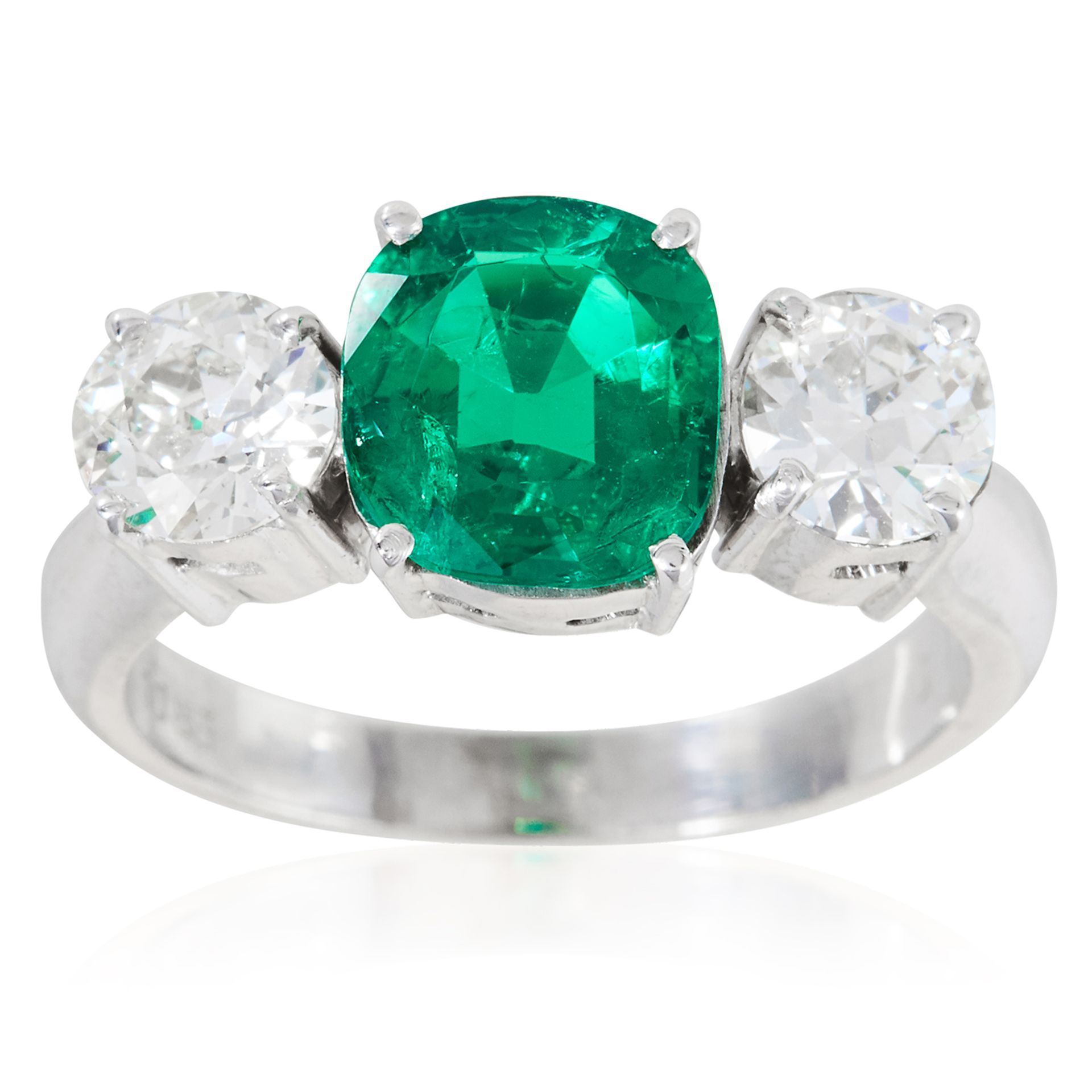 A COLOMBIAN EMERALD AND DIAMOND THREE STONE RING in platinum or white gold, the 1.42 carat cushion