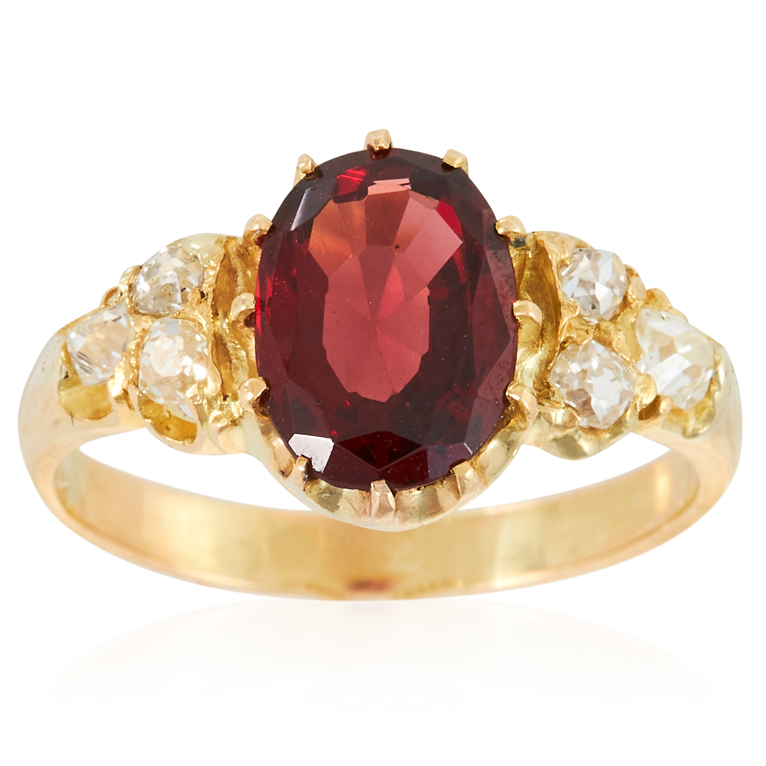 AN ALMANDINE GARNET AND DIAMOND DRESS RING in high carat yellow gold, set with an oval cut almandine