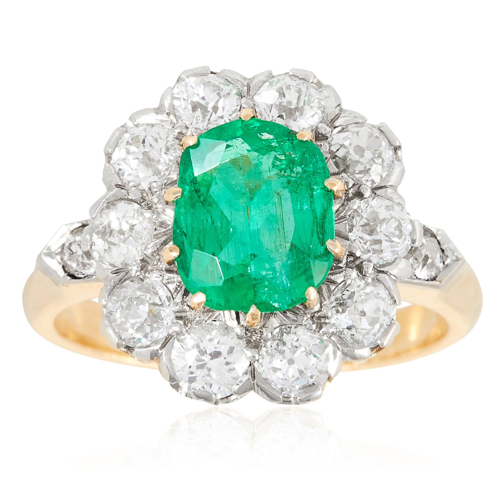 A 1.39 CARAT EMERALD AND DIAMOND CLUSTER RING in high carat yellow gold, set with an oval cut