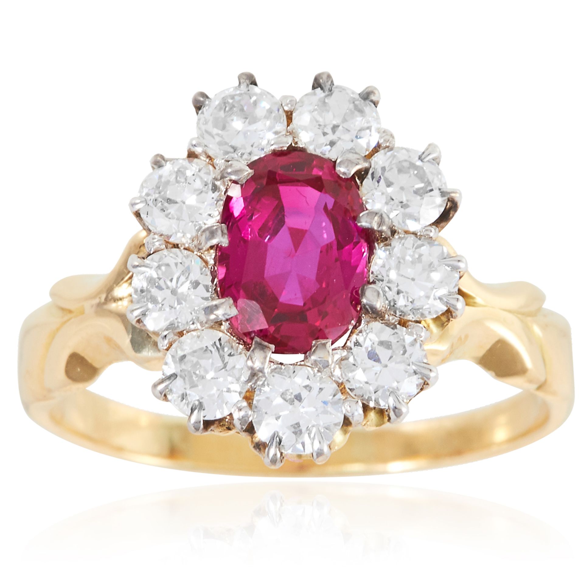 A 1.38 CARAT BURMA NO HEAT RUBY AND DIAMOND RING in 18ct yellow gold, the oval cut ruby encircled by