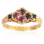 AN ANTIQUE GARNET AND EMERALD RING, CIRCA 1870 in 15 carat yellow gold, set with a quatrefoil