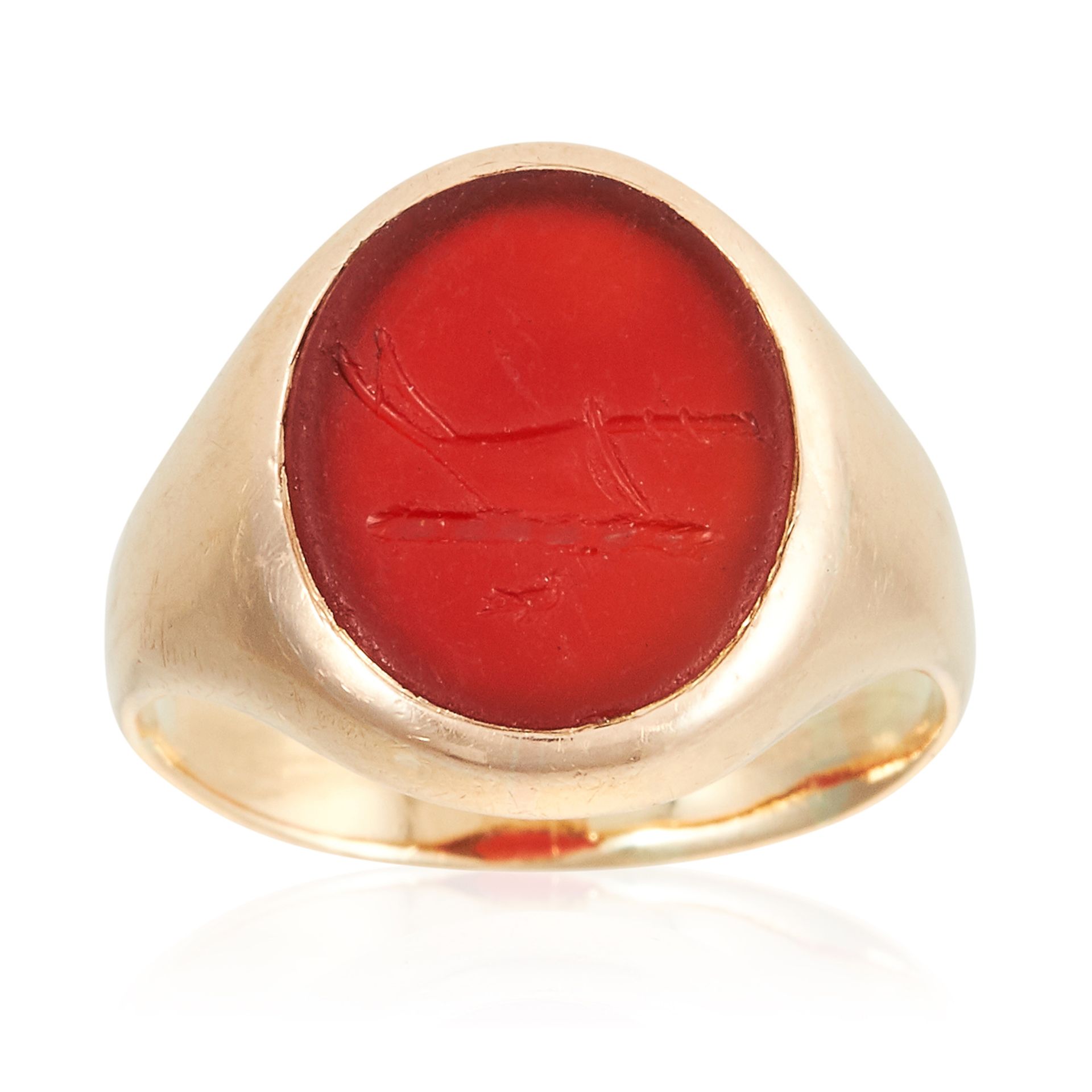 AN ANTIQUE CARNELIAN INTAGLIO SIGNET RING in high carat yellow gold, set with an oval piece of