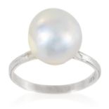 A PEARL DRESS RING in platinum, set with a single pearl of 10.1mm to a plain band, stamped Plat,