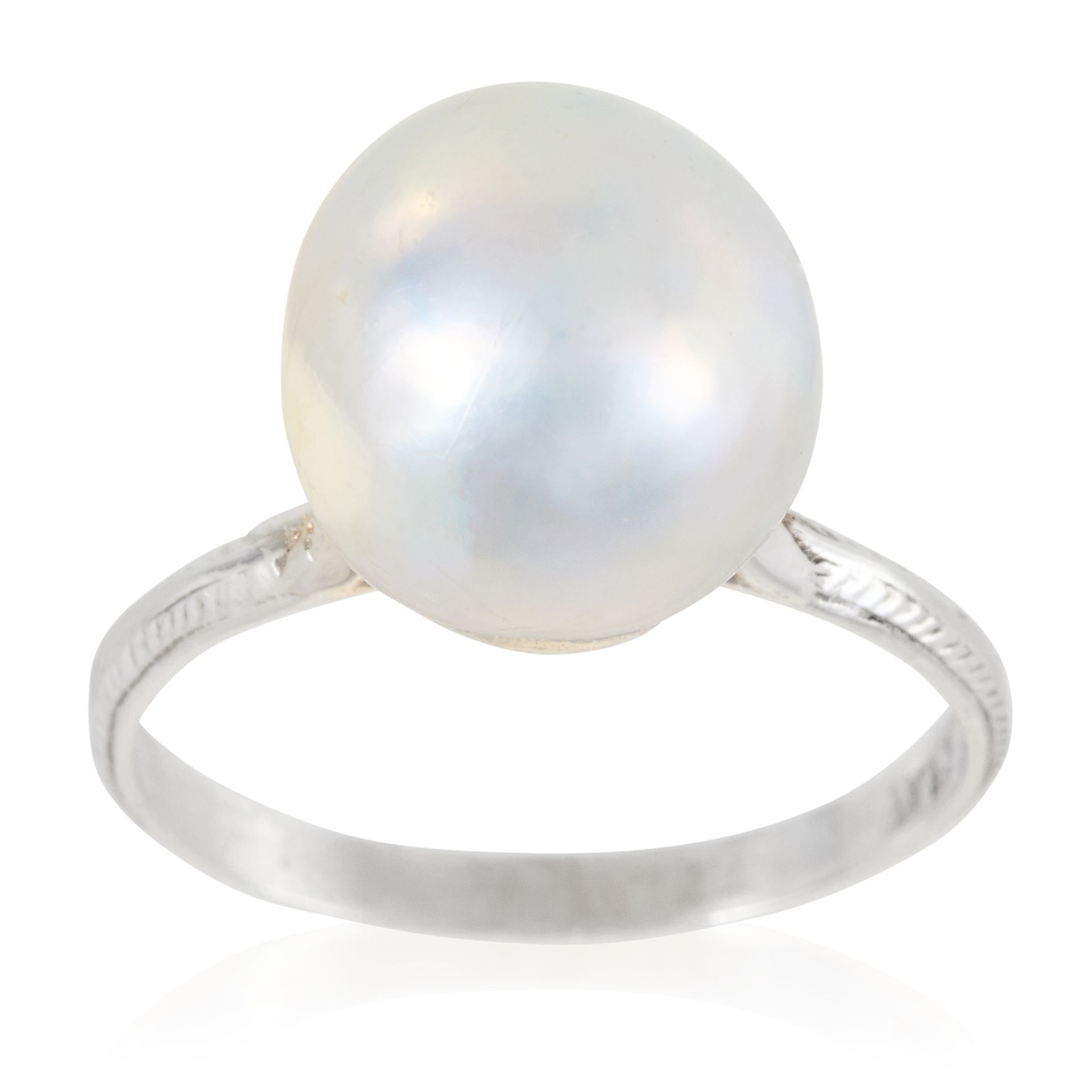 A PEARL DRESS RING in platinum, set with a single pearl of 10.1mm to a plain band, stamped Plat,