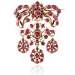 AN ANTIQUE GARNET BROOCH, SPANISH CIRCA 1900 the articulated ribbon motifs jewelled with oval, round