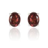 A PAIR OF COLOUR CHANGE GARNET EAR STUDS in 18ct white gold, each set with an oval cut colour change