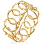 A FANCY LINK GOLD BANGLE in 18ct yellow gold, designed as a woven loop overlapping itself, British