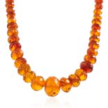 AN ANTIQUE NATURAL AMBER BEAD NECKLACE comprising a single row of one hundred and fourteen graduated