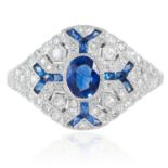 AN ART DECO SAPPHIRE AND DIAMOND RING in platinum or white gold, the oval cut sapphire within a