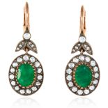 A PAIR OF EMERALD AND DIAMOND EARRINGS in 18ct yellow gold, set with two oval cut emeralds of