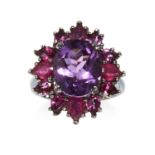 AN AMETHYST AND GARNET EARRING AND RING SUITE in silver gilt, comprising of a cluster of round, oval