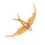 AN ANTIQUE PEARL SWALLOW BROOCH in high carat yellow gold, the body jewelled with five pearls,