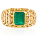 A VINTAGE EMERALD AND DIAMOND DRESS RING in high carat yellow gold, set with an emerald cut