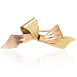 A VINTAGE BOW BROOCH, CARTIER in 14ct yellow gold, in abstract bow design in two tone gold, signed