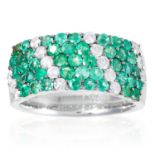 AN EMERALD AND DIAMOND DRESS RING in 18ct white gold, jewelled with round cut diamonds and emeralds,