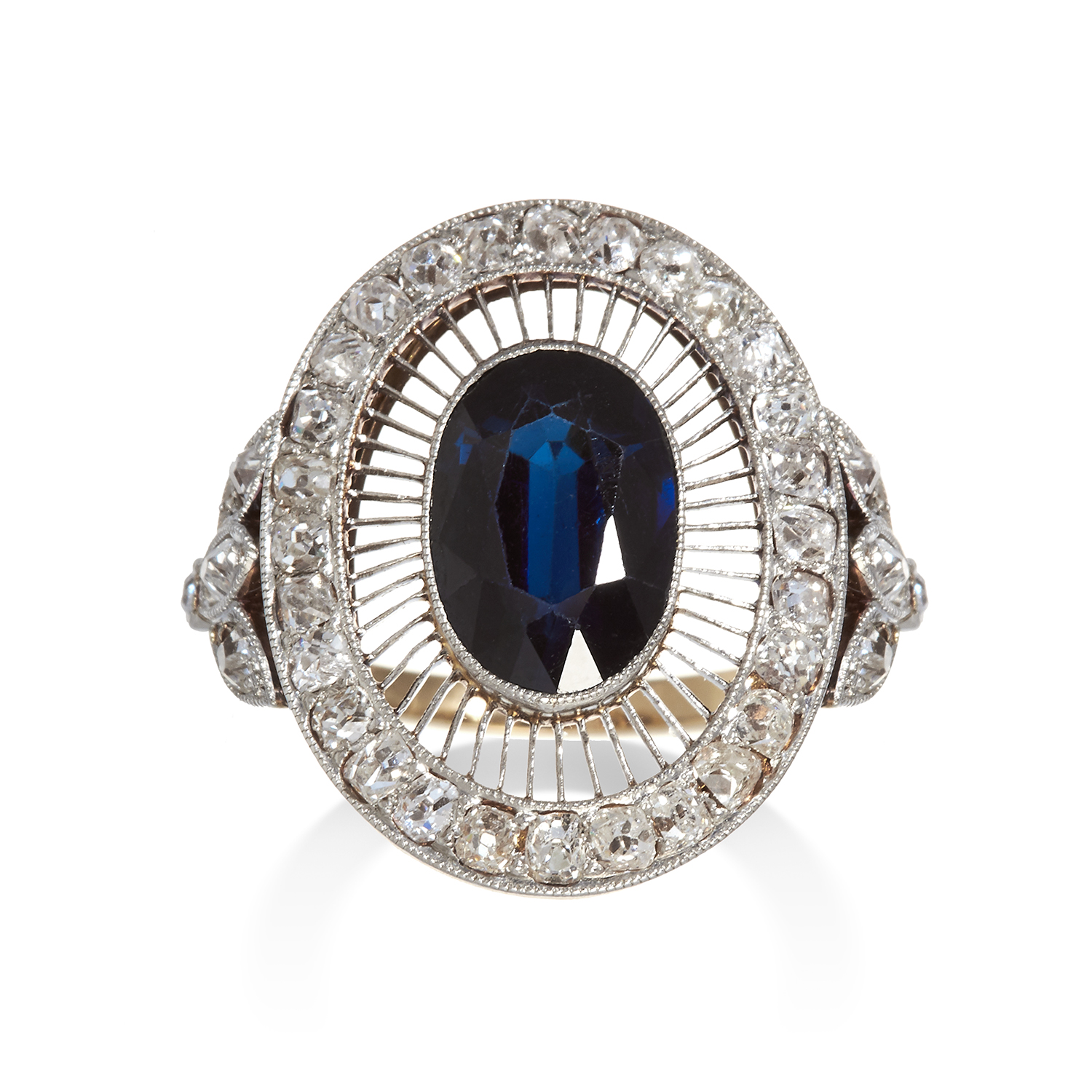 AN ART DECO SAPPHIRE AND DIAMOND DRESS RING in yellow gold, set with a central oval cut sapphire