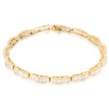 A 5.00 CARAT DIAMOND LINE BRACELET in 18ct yellow gold, set with princess cut diamonds totalling