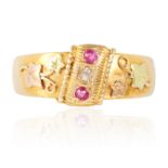 AN ANTIQUE RUBY AND DIAMOND RING, CIRCA 1901 in 18ct yellow gold, set with two round cut rubies
