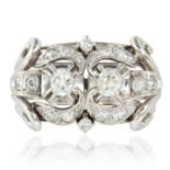 AN ART DECO DIAMOND RING in platinum and 18ct white gold set with two round cut diamonds within