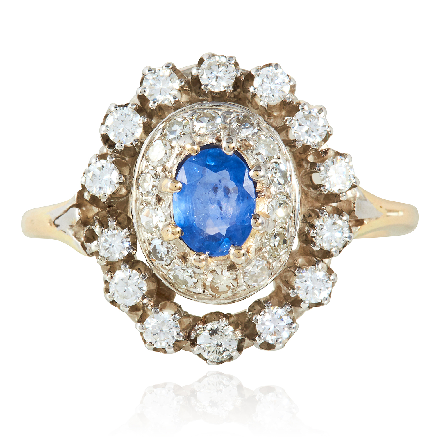 A SAPPHIRE AND DIAMOND RING in yellow gold and platinum, the oval cut sapphire within concentric