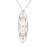 AN ART DECO DIAMOND AND PEARL PENDANT in platinum, the openwork scrolling body set with two pearls